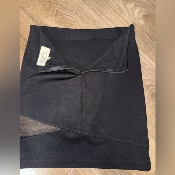 Black mini skirt BB Dakota featuring a unique diagonal sheer mesh panel detail.4 - Picture 3 of 8
